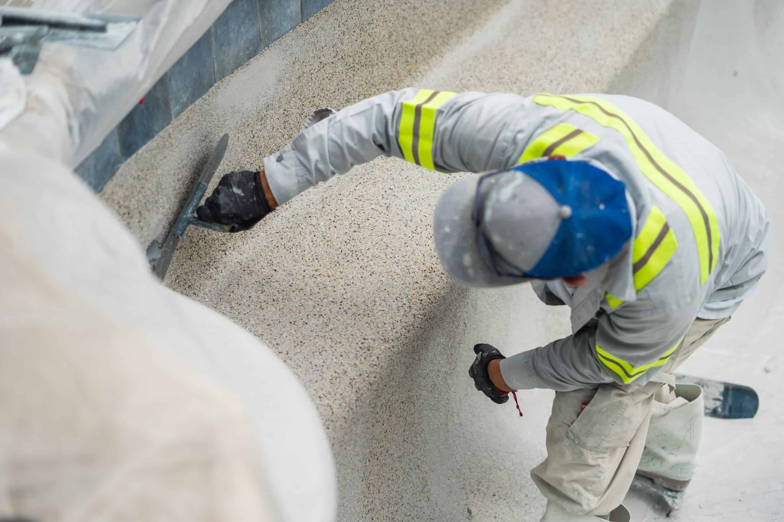 Man replastering pebblecrete