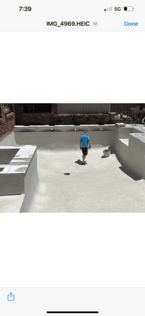 Man renovating an empty pool