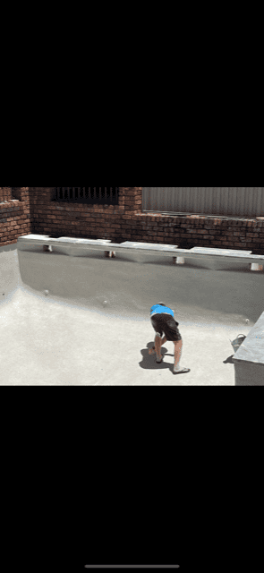 man bending over in an empty pool
