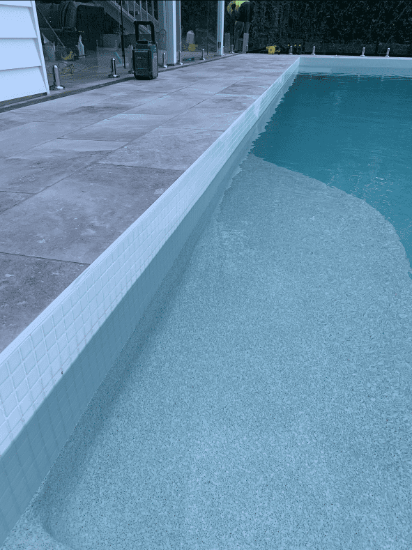 Edge of a pool with white tiles
