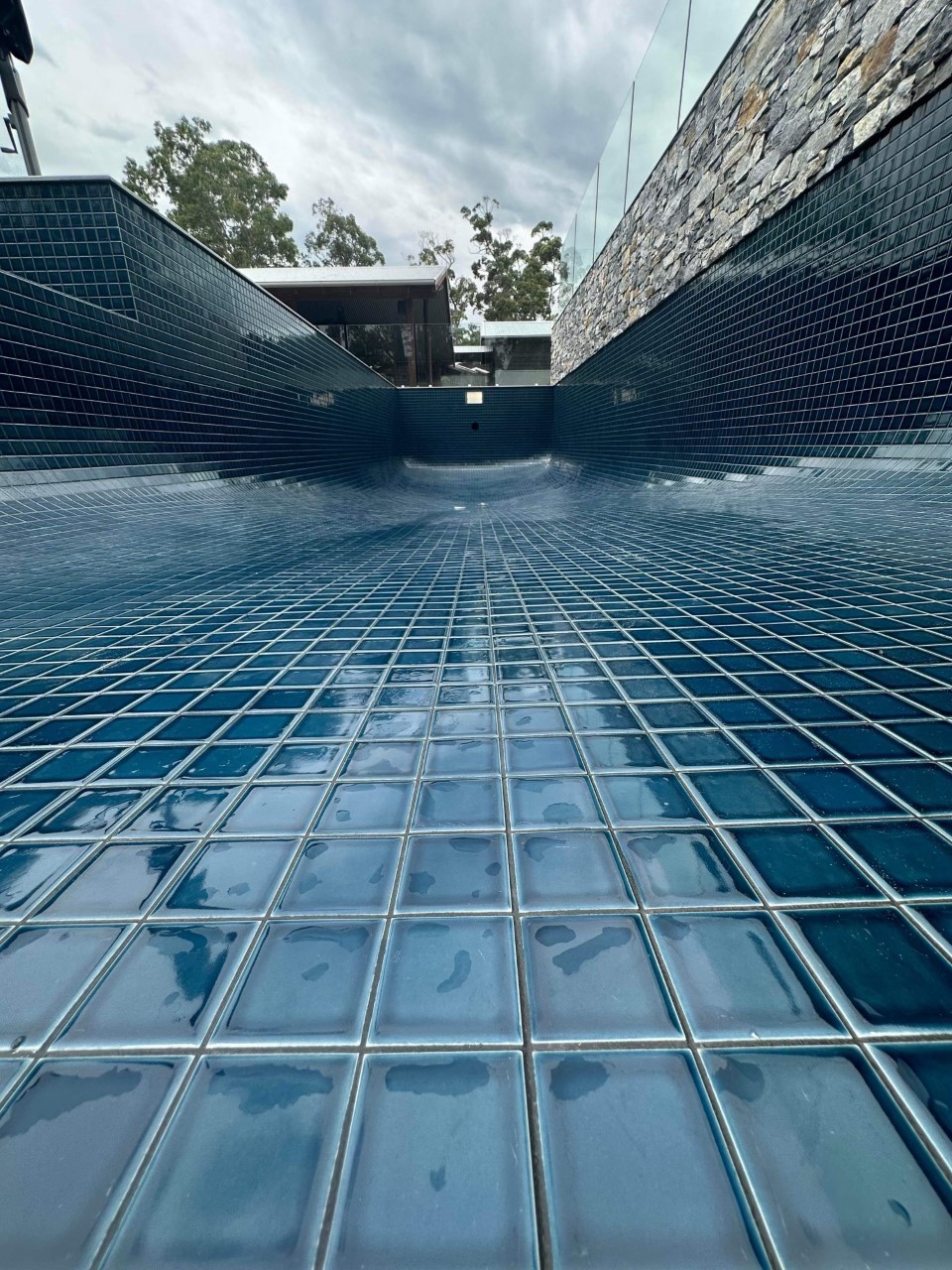 Empty pool with shiny blue tiles
