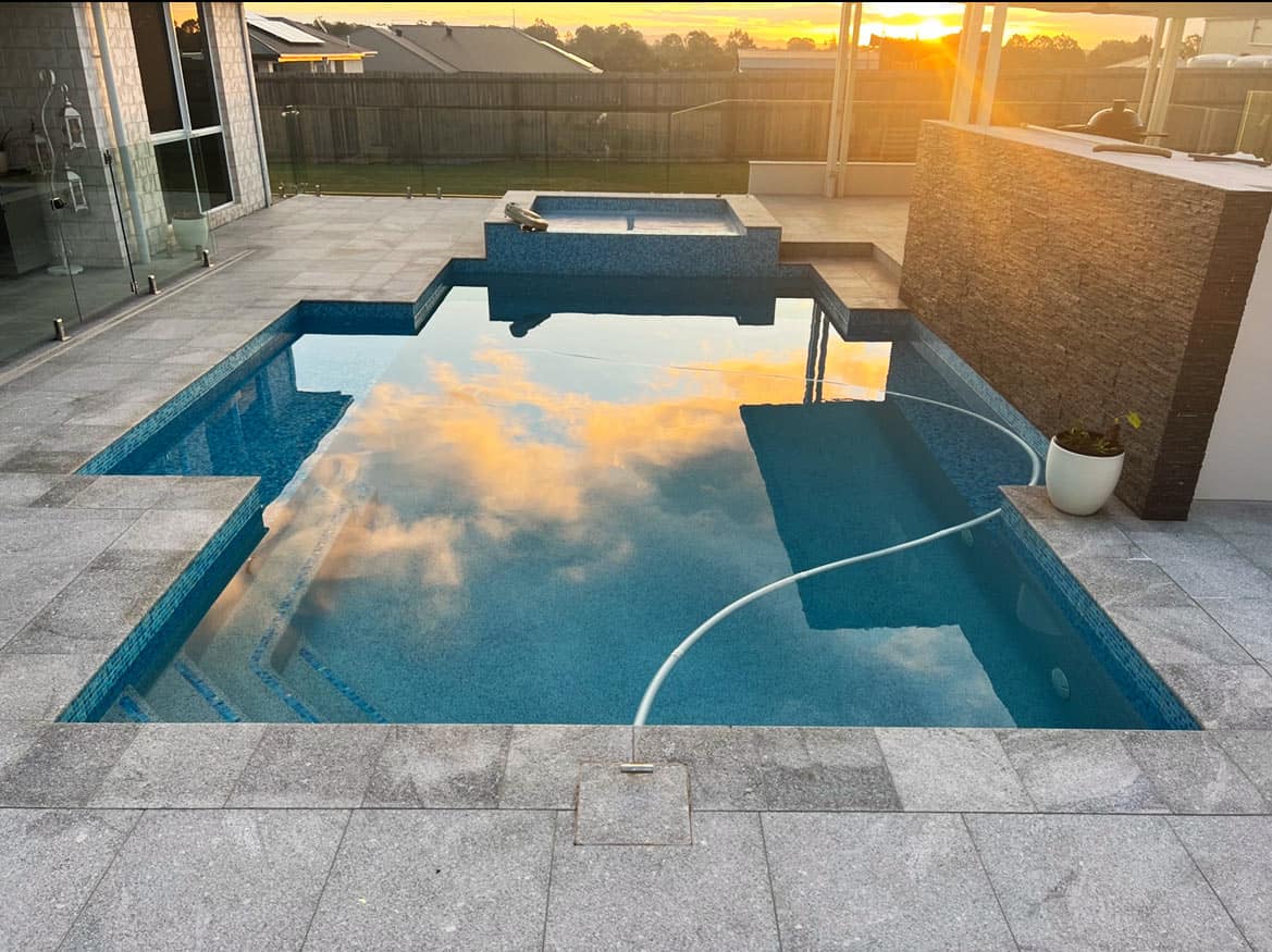 newly renovated pool blue pebblecrete and tiles with grey tiles