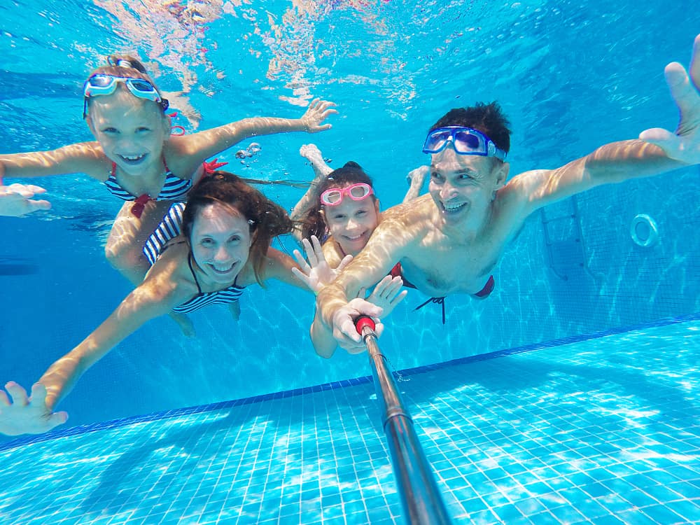 underwater phot of family swimming in pool